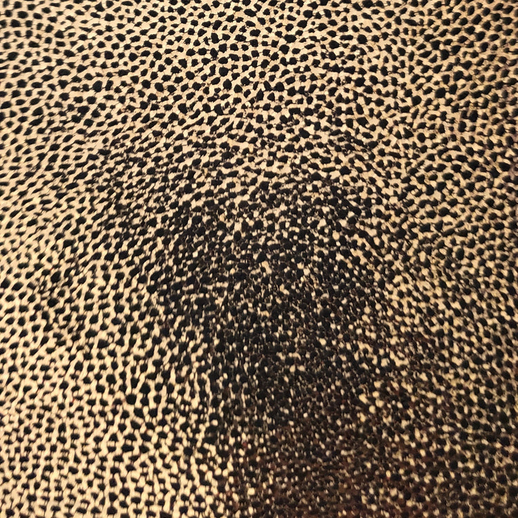 Close-up of bronze foiled leather with a micro bubbly pattern