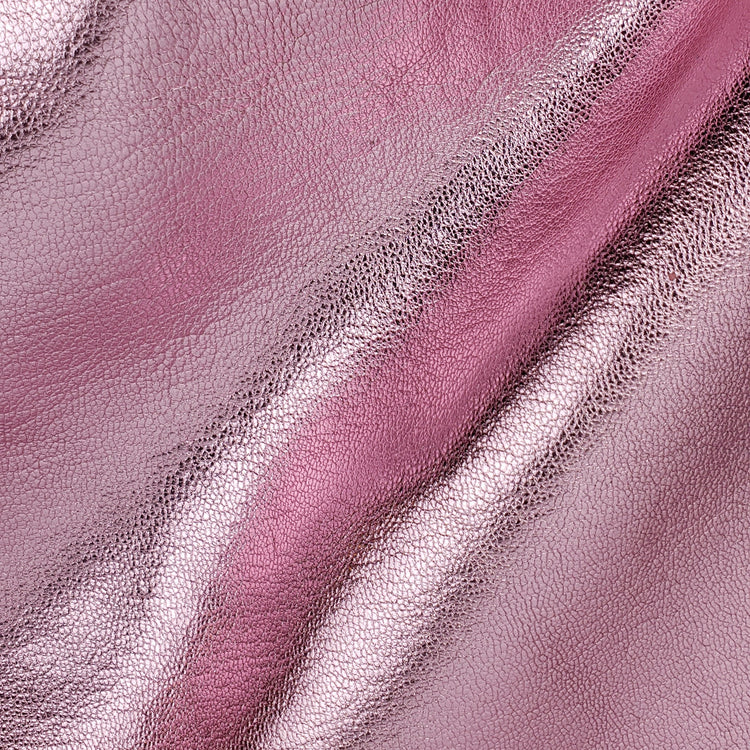 Close-up of a light pink metallic leather with a subtle grain texture