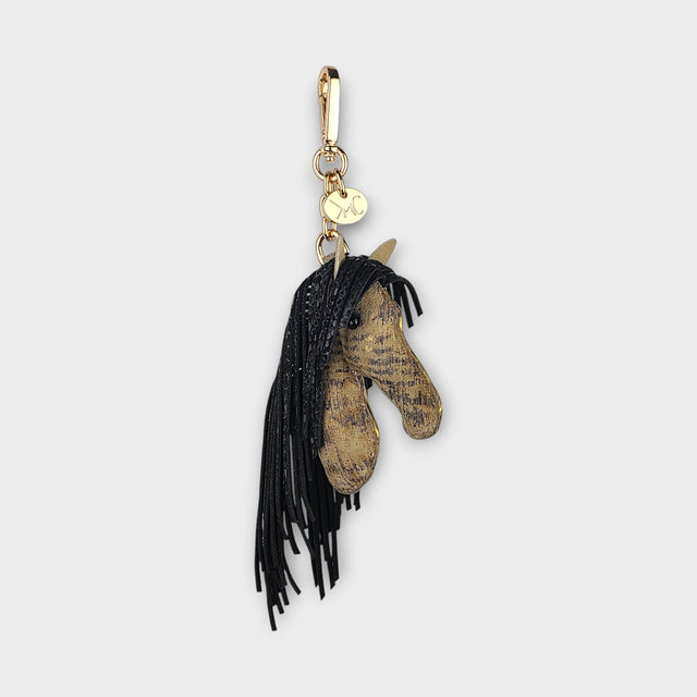 Horse head handbag charm with black heavy fringe as the mane on a light gray background.