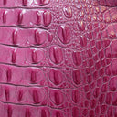 Close-up of pink crocodile skin texture