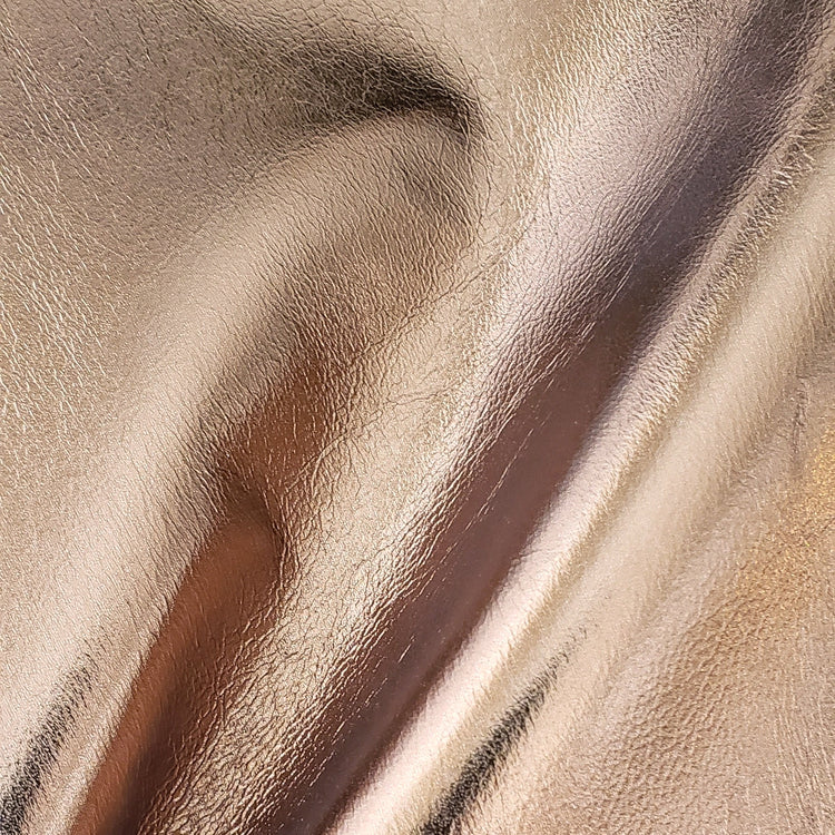 Close-up of beige leather texture with visible grain and folds